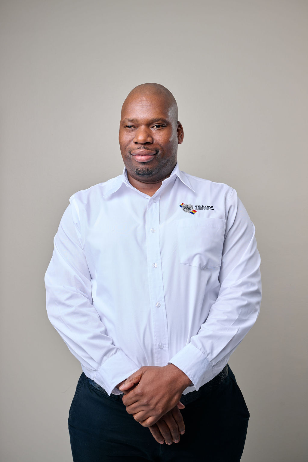 A Vela-Tech Security head office staff member in uniform